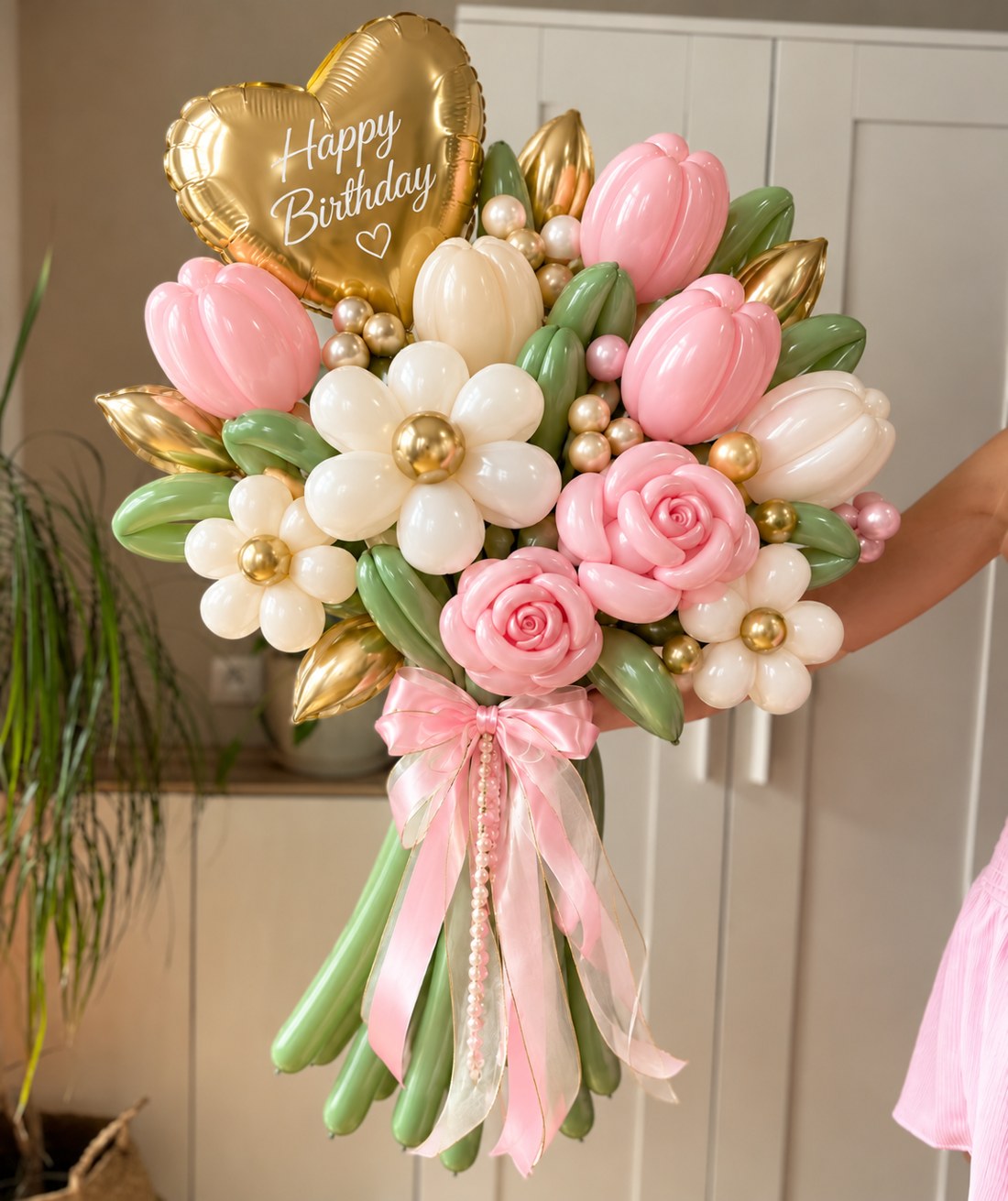 Tulips, roses and daisies with a gold birthday heart and soft ribbon details.